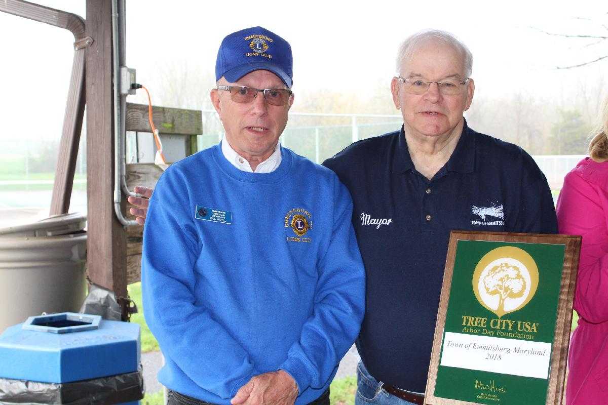 Photo of Mayor Don Briggs and Lions Club President Bill Wivell holding the Town's first Tree City USA award